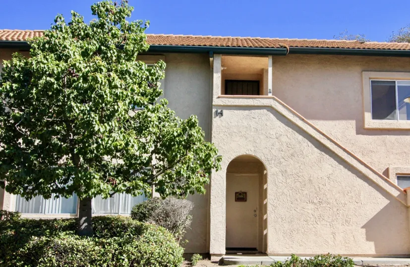 Two story residence with trees & bushes inside The Falls in Rancho Bernardo CA