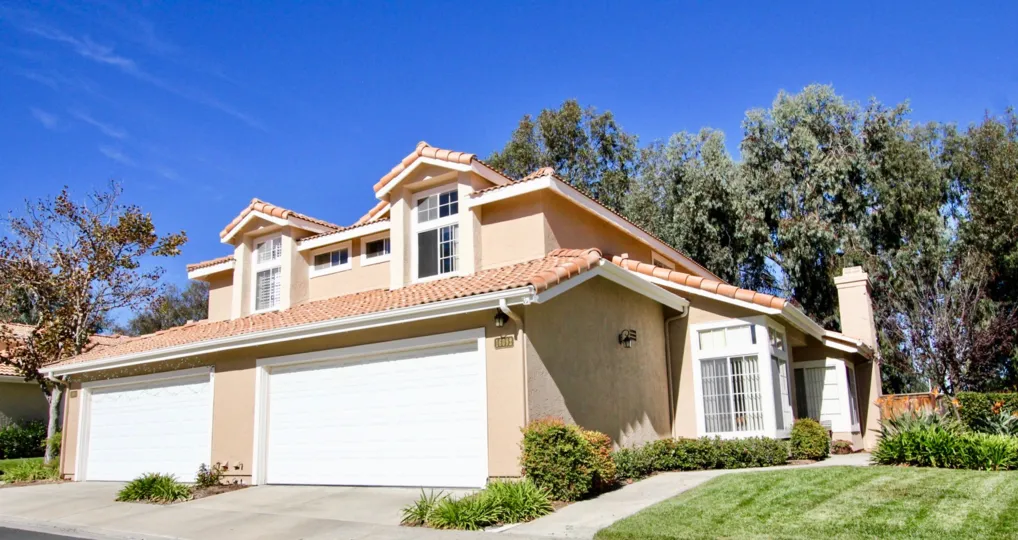 Pink home with two garages inside Tierra Del Sol in Rancho Bernardo CA