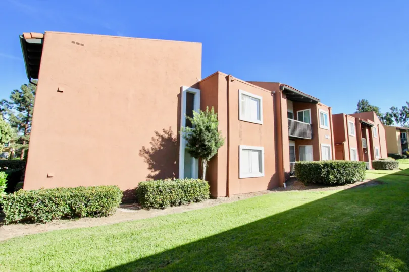 Two story red units with grass field inside the Waterbridge Community in Rancho Bernardo CA