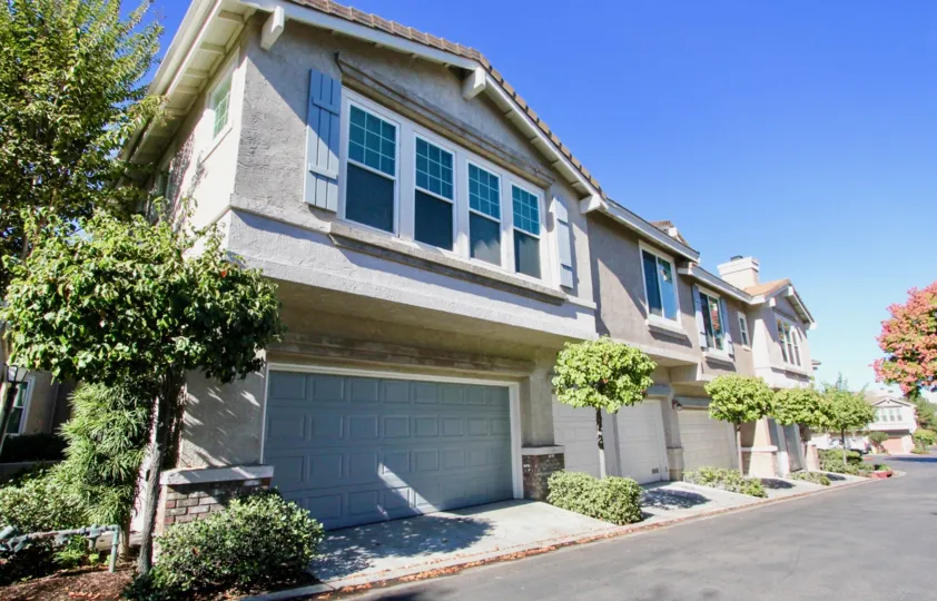 Gray units with a garage door & plants inside Windham in Rancho Bernardo CA