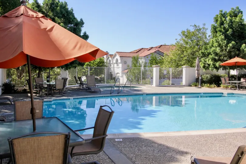Fabulous swimming pool with sunshine having tent and sitout near villas with trees of Ambiance area of San Marcos