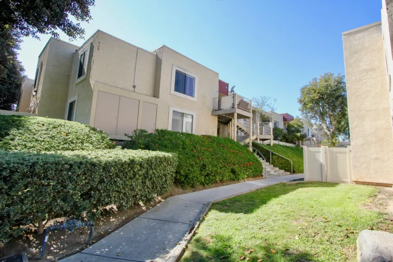 A sunny day in the Autumn Heights with residential building and plants.