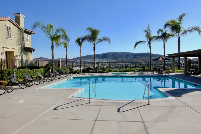 Nice swimming pool with palm trees and sitout on sunny day in Calico Bluffs of San Marcos