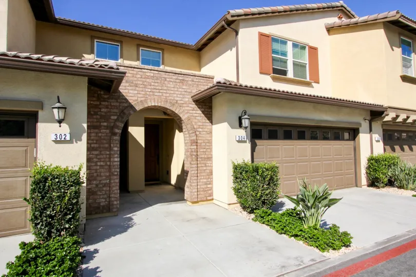 Archway entrance leading to townhomes at Candera in San Marcos California