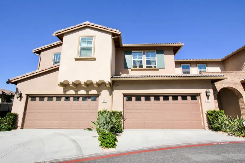 Attached home with double car garage located in a cul-de-sac with contemporary styling and spaanish inspired roof in San Marcos
