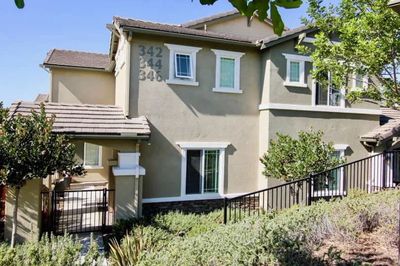 A three-unit residence painted in gray in a hilly Capalina Pines community.