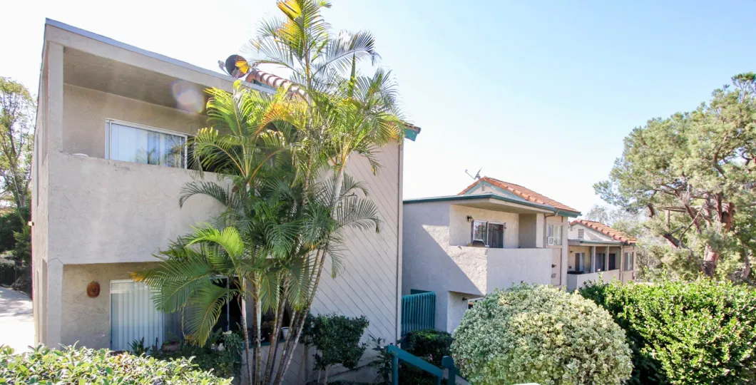 A series of two-storey townhomes in a hilly landscape in Capalina Pines neighborhood.