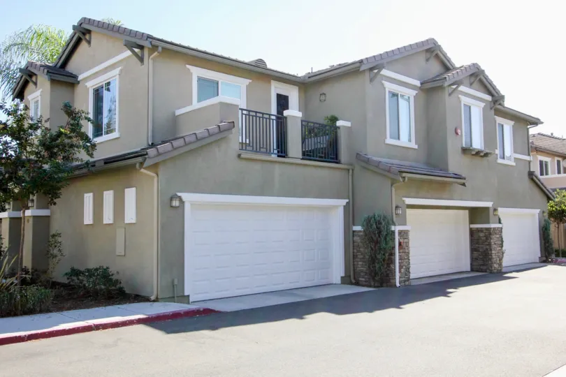 A two-storey residence painted in gray color in the Carriage Walk community.