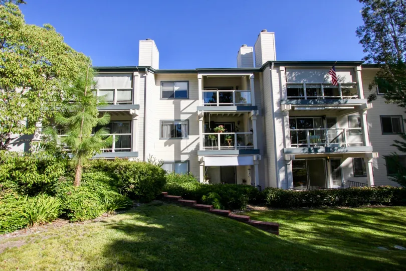 A sunny day in the area of Chateau, outside, balcony, condos, trees, stairs, american flag