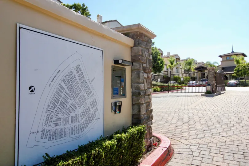 Community map, communication panel and gated entryway on a brick paved road at Coronado Ranch