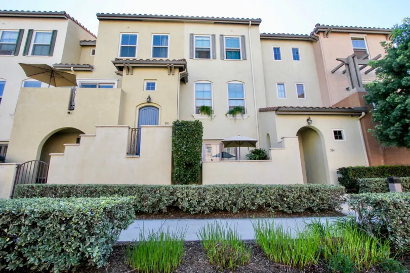 A sunny day in the area of Coronado Ranch, outside, condo, bushes, plants, umbrella