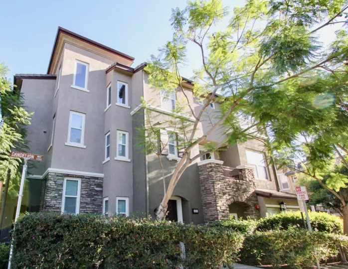 Corner side view with trees of Creekside Cottages community in San Marcos, CA