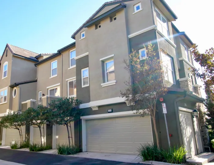 A sunny day outside of the Creekside Cottages in San Marcos, CA with their garages