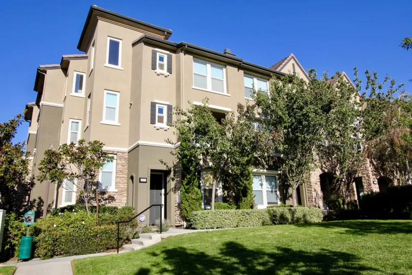 The Creekside Cottages campus is filled with lush green grass