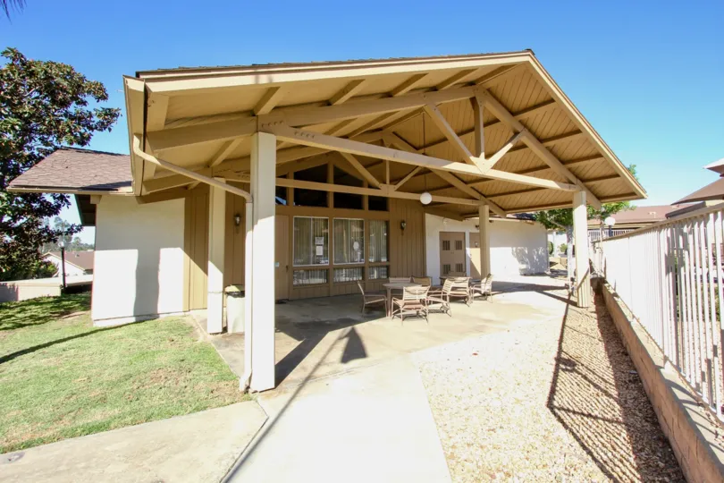 A covered seating area with exposed trusses in the Fairway Knolls community.