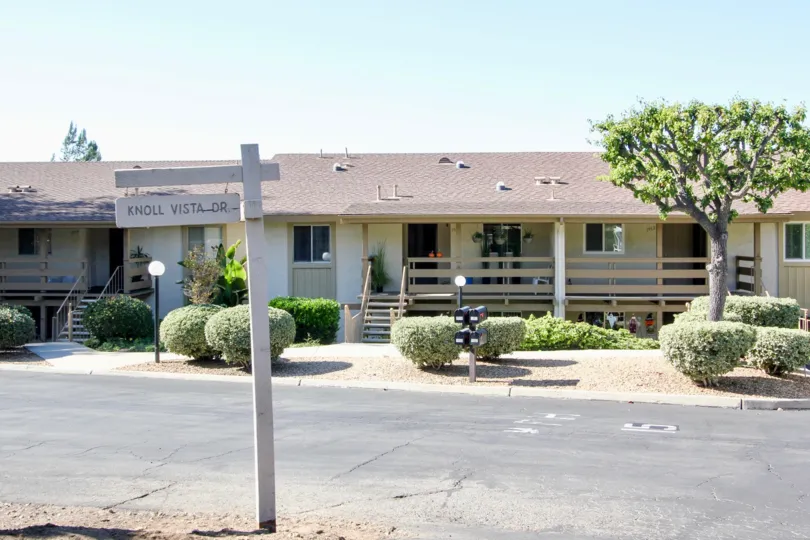 Singe story home with a pink roof inside Fairway Knolls in San Marcos CA
