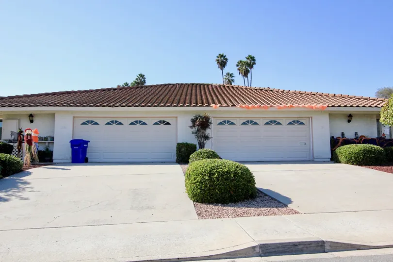 Home with a pink roof & two garages at Highland Casitas in San Marcos CA