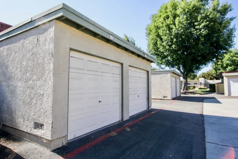 Two garage doors in one building with multiple buildings in Lake Park Terrace community.