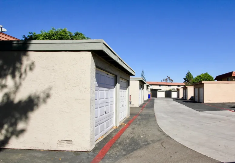 A sunny day in the area of Lake Park Terrace, parking lot, garages, trees, outside