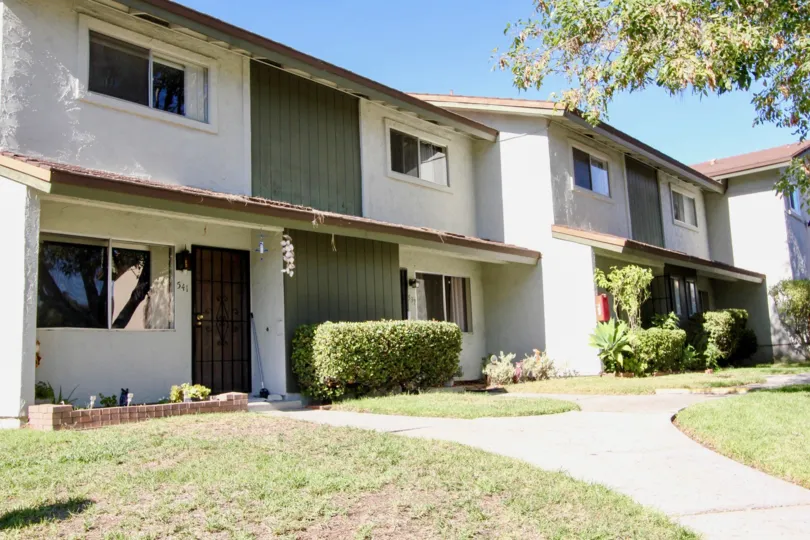 Two story condos in front of sidewalks at Lake Park Villas in San Marcos CA