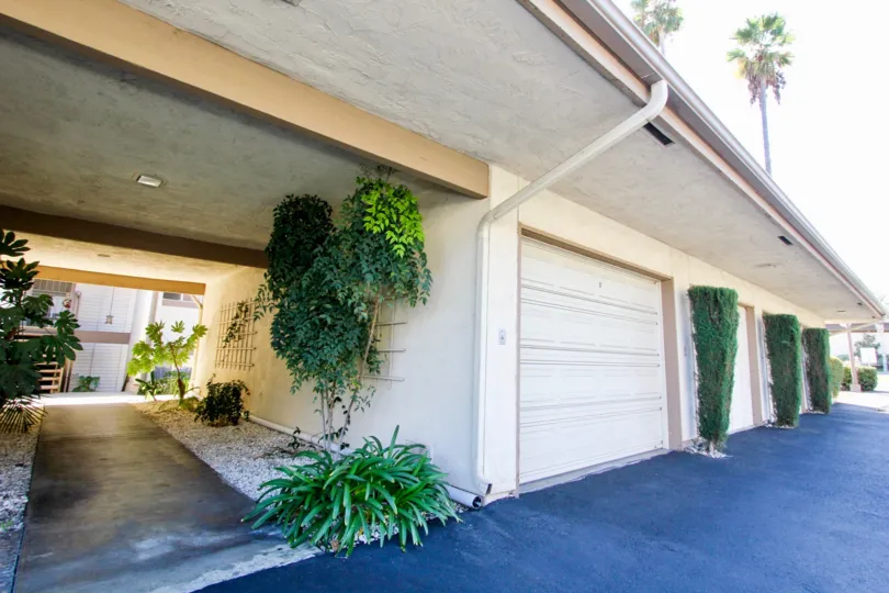 A sunny day in the area of Lake San Marcos Gardens, condos, garage, sidewalk, trees, driveway