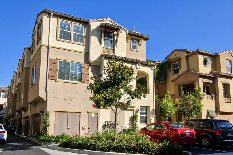 Three story residence with fake wooden shutters in Laurel at San Marcos CA
