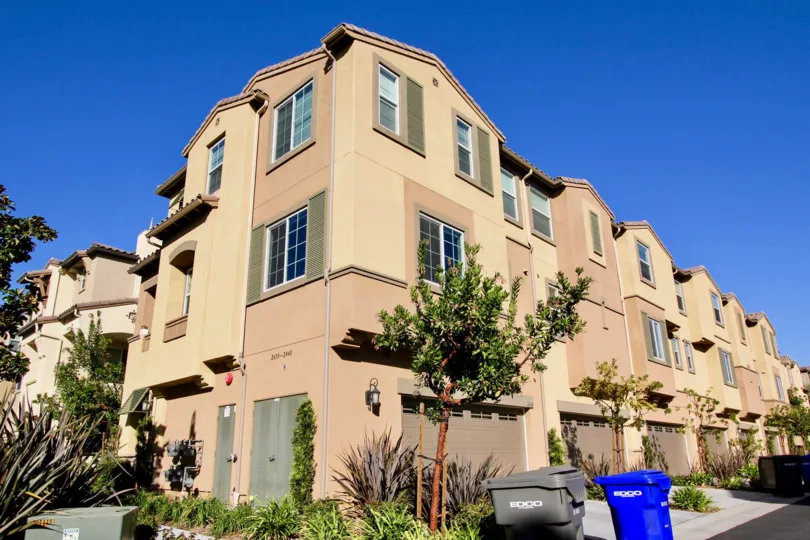 Three story brown units with garages in Laurel at San Marcos CA