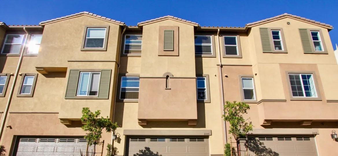 Three story home with large brown garage doors in Laurel at San Marcos CA