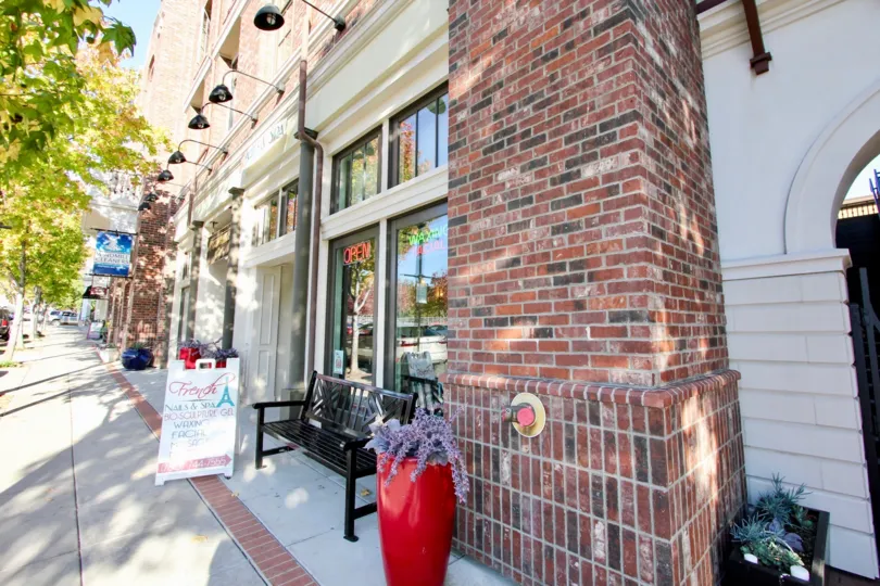 Brick chimney next to a store with glass windows at MarketWalk in San Marcos CA