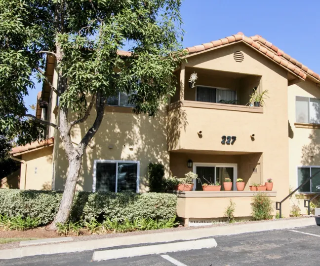 A sunny day in the area of Mission Park, outside, trees, condos, balcony, door