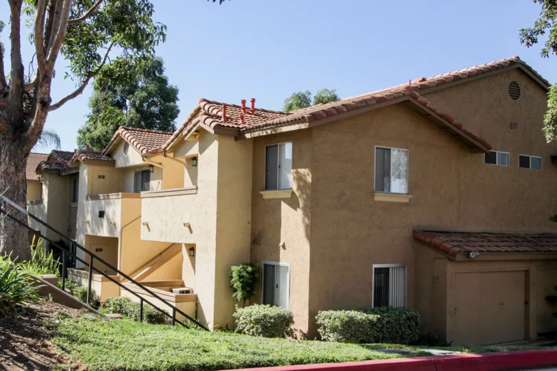 Two story housing on a lush green hillside in the Mission Park in San Marcos California