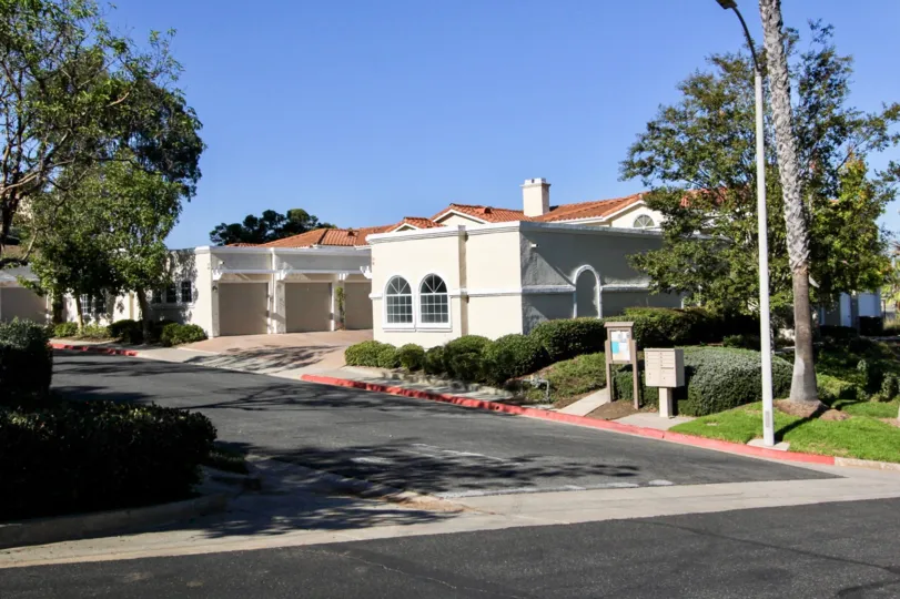 Two windows on a white building near a driveway at the Panorama in San Marcos CA