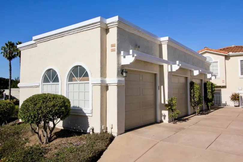 Bright sunny day with trees and parking place of villas in Panorama of San Marcos