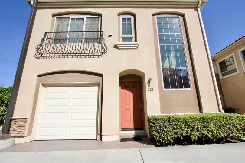 A two-storey residence with a curved terrace and tall window in Richland Villas neighborhood.