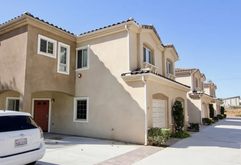 Two story brown homes with garages in the Richland Villas in San Marcos CA