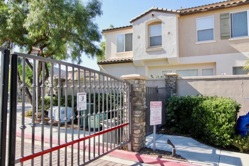 Automatic gate with a fence and building in the Savona Community in San Marcos, CA.