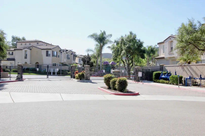 THE BUNGALOWS IN THE SAVONA WITH THE TREES, GATES, PLANTS, MACHINE, THAR ROAD