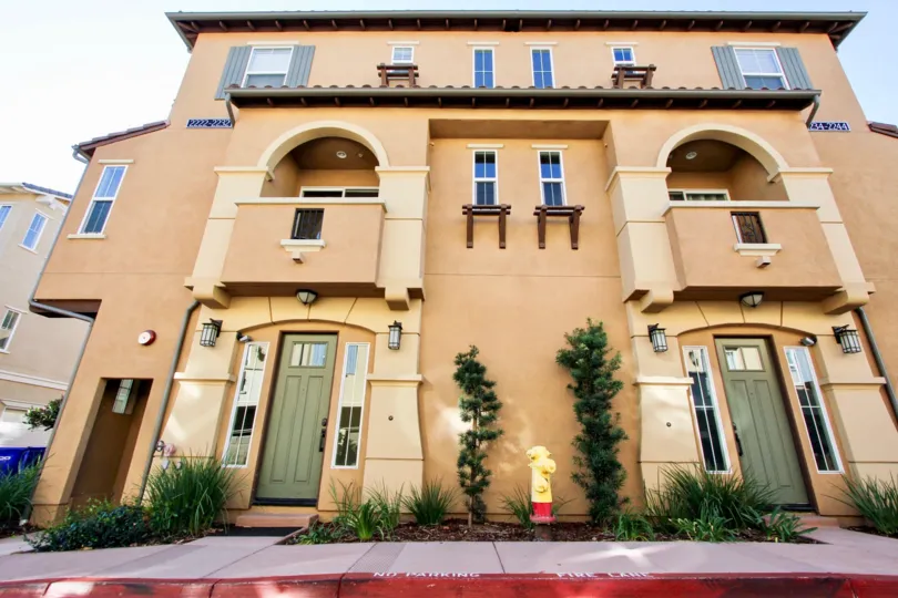 Three story building with green artistic doors in Solaire in San Marcos CA