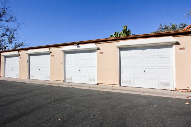 A sunny day in the area of Sommerset By The Lake, parking lot, outside, garages, tree, sky