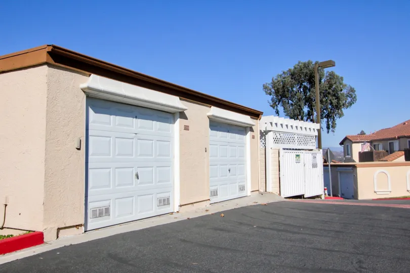 Pink garage structure with white doors inside Sommerset By the Lake in San Marcos CA