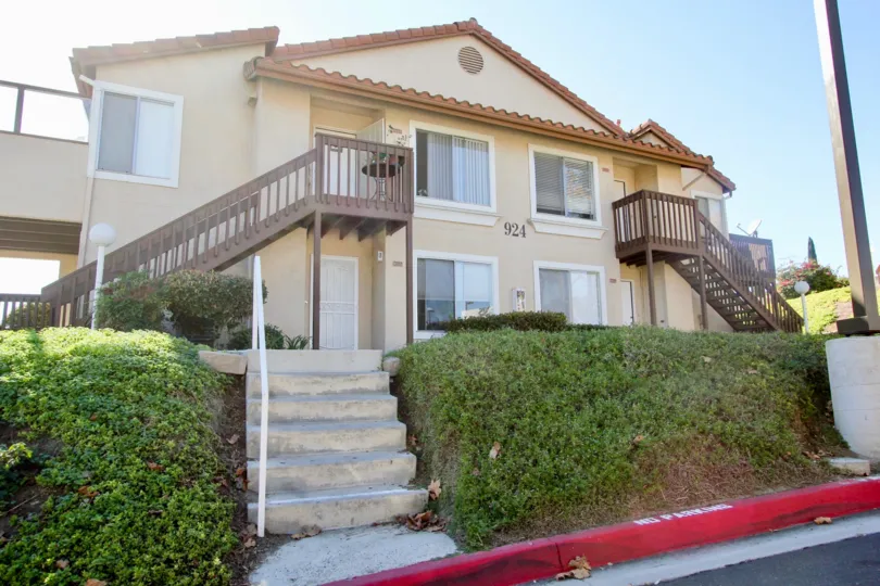Two story brown building with steps in Sommerset By The Lake in San Marcos CA