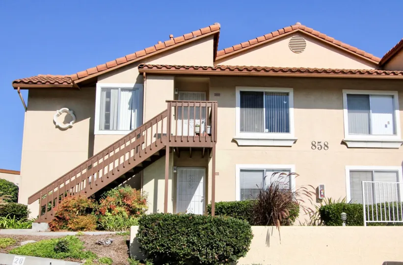 A two-storey residence with exterior staircase in the Sommerset By the Lake neighborhood.