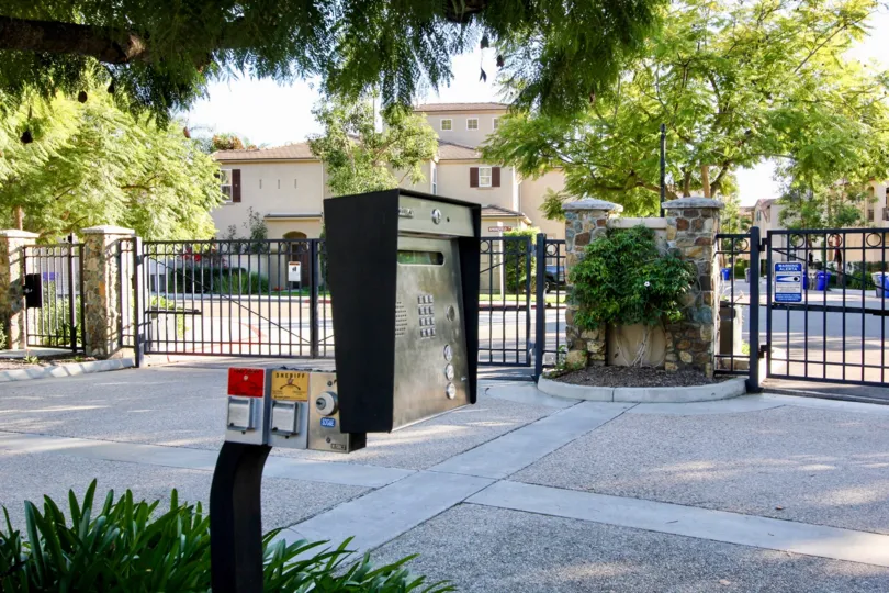 A metered parking lot in the Springfield neighborhood with metal gates.