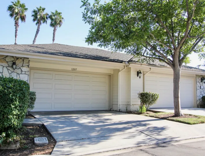 THE 1207 HOUSE IN THE SURISE POINTE WITH THE SHUTTER, LAMPS, TREES, PLANTS