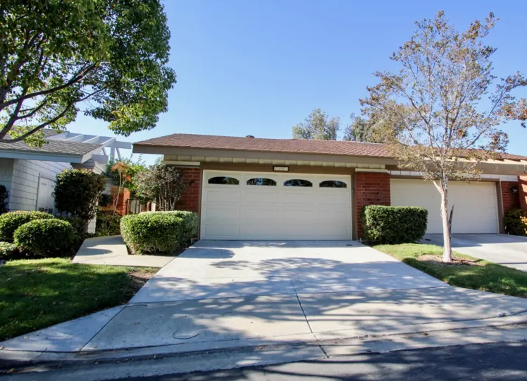 Two garage doors sit on the front of a brick home in the Sunrise Pointe community