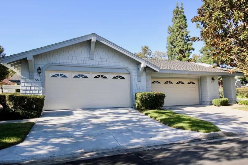 Blue home with a white garage door inside the Sunrise Points in San Marcos CA
