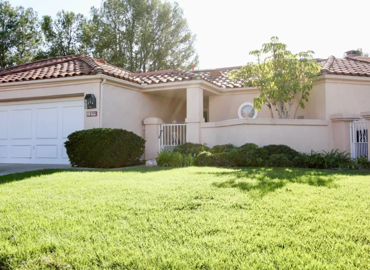 Front of gated one story home in The Colony in San Marcos