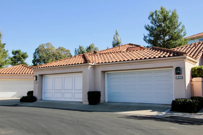 The Colony beige building with white garage doors San Marcos California