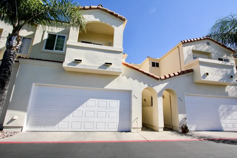 View of balconies and white two-car garages at Villa Aspara in San Marcos, California