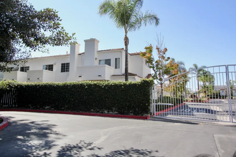 Villa Aspara white building and gated entry San Marcos California